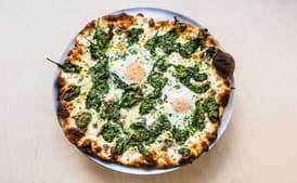 Breakfast Pizza with Sausage, Eggs, Spinach, and Cream