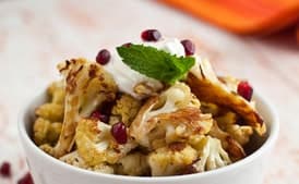 Cumin Seed Roasted Cauliflower with Salted Yogurt, Mint, and Pomegranate Seeds