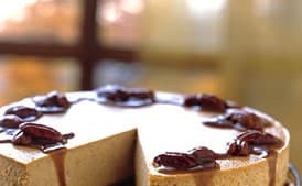 Spiced Pumpkin Cheesecake with Caramel-Bourbon Sauce